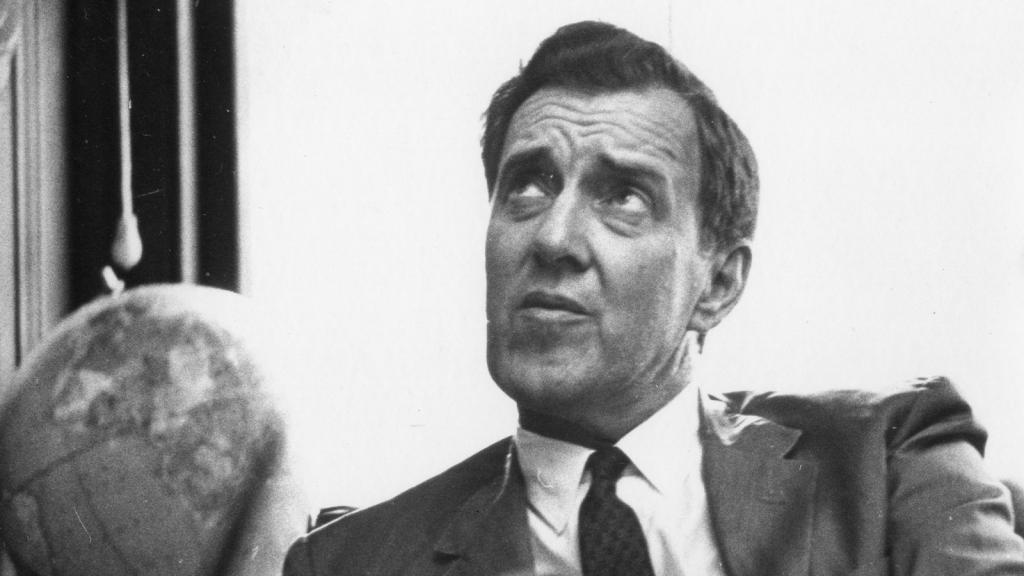 Photo of Senator Edmund Muskie at his desk with globe in background