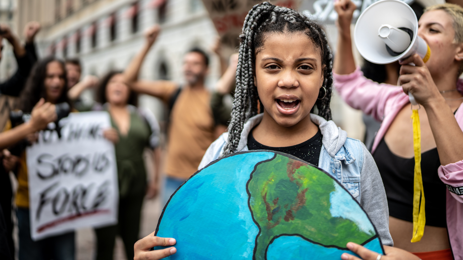 Portrait of teenage girl holding signs during on a demonstration for environmentalism